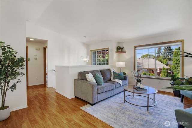 8708 11th St NE, Lake Stevens, WA 98258 - living area featuring wood finished floors, a chandelier, and healthy amount of natural light
