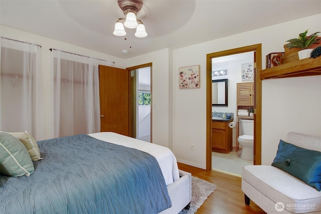 8708 11th St NE, Lake Stevens, WA 98258 - bedroom with wood finished floors, ensuite bathroom, baseboards, and ceiling fan