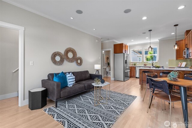 31 Etruria St Unit B, Seattle, WA 98109 - living room with light wood-style flooring, ornamental molding, recessed lighting, and baseboards