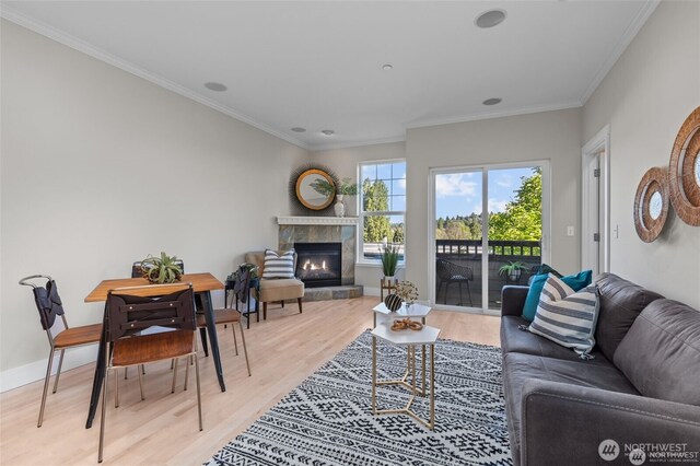 31 Etruria St Unit B, Seattle, WA 98109 - living room with light wood-style floors, a glass covered fireplace, ornamental molding, and baseboards