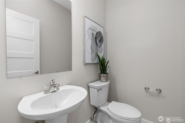 31 Etruria St Unit B, Seattle, WA 98109 - half bathroom with a sink, toilet, and baseboards