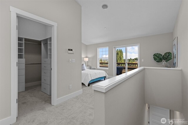 31 Etruria St Unit B, Seattle, WA 98109 - carpeted bedroom with a walk in closet, baseboards, access to outside, lofted ceiling, and a closet