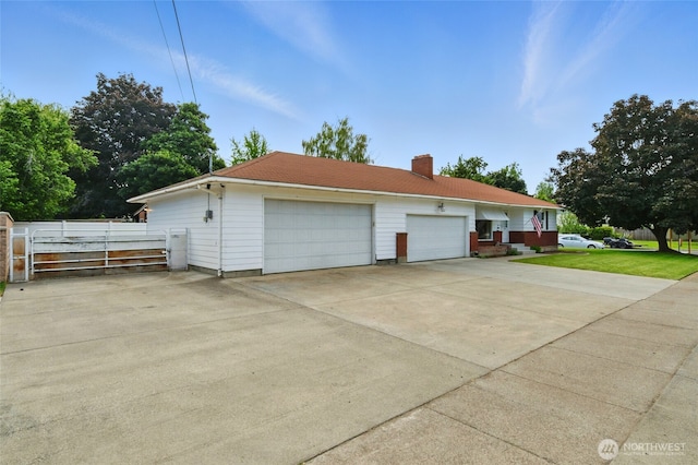 1511 Howard St, Walla Walla, WA 99362 - view of property exterior featuring a chimney, a garage, and driveway