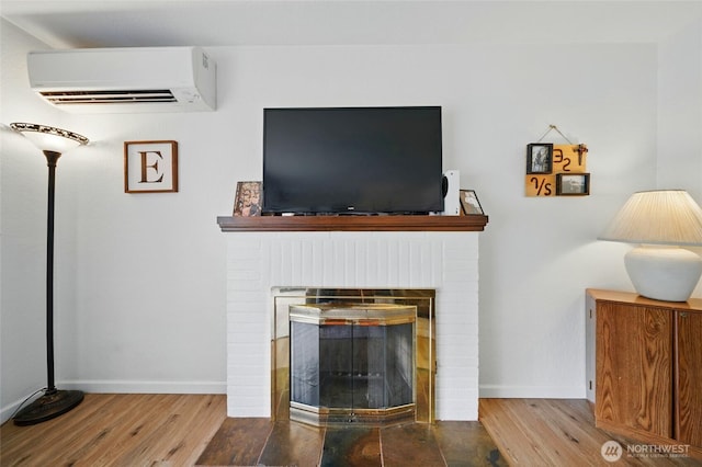 1511 Howard St, Walla Walla, WA 99362 - detailed view of a wall mounted air conditioner, wood finished floors, a brick fireplace, and baseboards