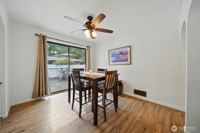 1511 Howard St, Walla Walla, WA 99362 - dining area with arched walkways, light wood-style floors, a ceiling fan, and baseboards