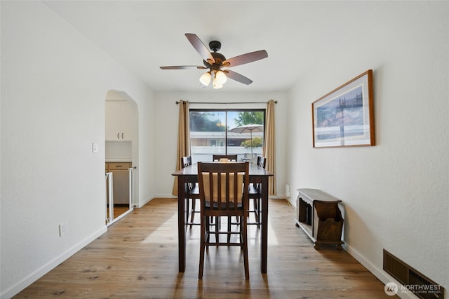 1511 Howard St, Walla Walla, WA 99362 - dining space with arched walkways, ceiling fan, light wood-style floors, and baseboards