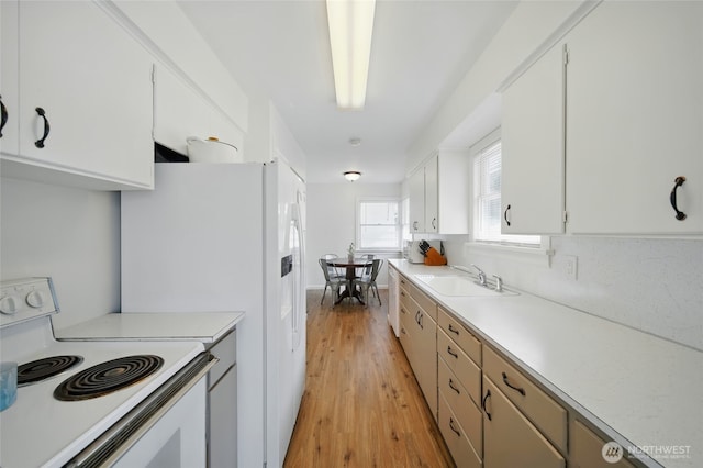 1511 Howard St, Walla Walla, WA 99362 - kitchen featuring white appliances, a sink, light countertops, and light wood-style floors