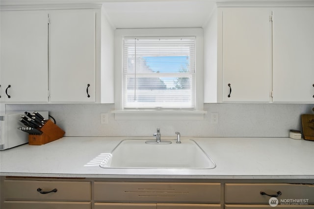1511 Howard St, Walla Walla, WA 99362 - kitchen featuring a sink, light countertops, and white cabinets