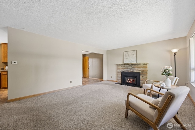 29922 5th Ave SW, Federal Way, WA 98023 - living room with light colored carpet, a stone fireplace, baseboards, and a textured ceiling