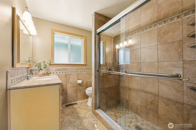 29922 5th Ave SW, Federal Way, WA 98023 - bathroom with vanity, tile walls, a shower stall, and toilet
