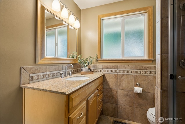 29922 5th Ave SW, Federal Way, WA 98023 - full bath with vanity, toilet, tile walls, wainscoting, and a shower with door