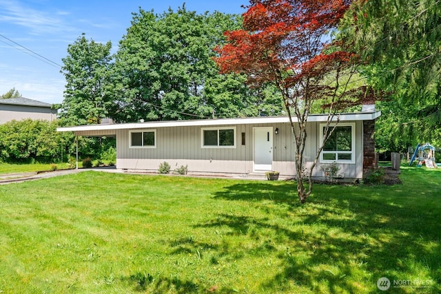 924 1st St, Sultan, WA 98294 - single story home with a carport, a front yard, a playground, and driveway
