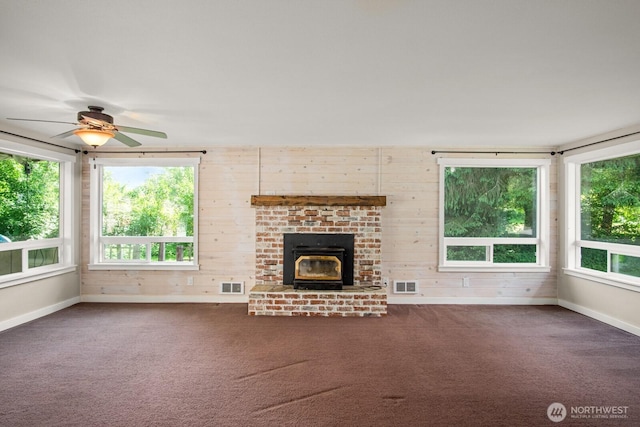 924 1st St, Sultan, WA 98294 - unfurnished living room with carpet floors, baseboards, wooden walls, and a ceiling fan