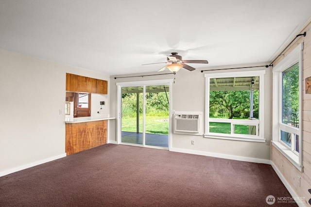 924 1st St, Sultan, WA 98294 - unfurnished living room featuring carpet floors, a ceiling fan, an AC wall unit, and baseboards