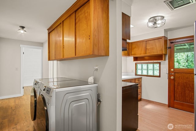 924 1st St, Sultan, WA 98294 - laundry room with independent washer and dryer, light wood-type flooring, baseboards, and cabinet space