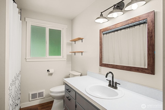 924 1st St, Sultan, WA 98294 - full bathroom with vanity, toilet, wood finished floors, baseboards, and curtained shower