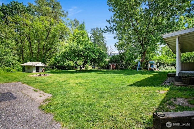 924 1st St, Sultan, WA 98294 - view of grassy yard featuring a playground and an outdoor structure