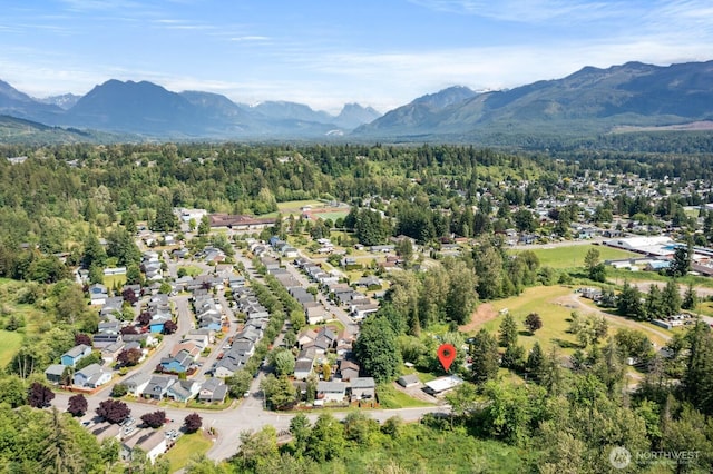 924 1st St, Sultan, WA 98294 - aerial perspective of suburban area featuring a mountainous background and a heavily wooded area