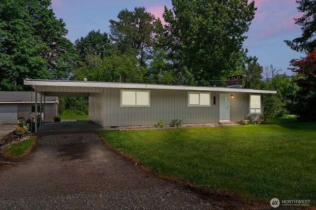 924 1st St, Sultan, WA 98294 - view of front of property with dirt driveway, a front yard, and a carport