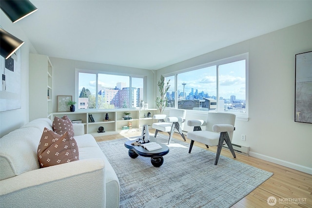 919 2nd Ave W Unit 601, Seattle, WA 98119 - living area featuring a skyline view, wood finished floors, and baseboards