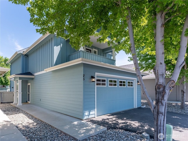 2452 NW Columbia Ave Unit 25, East Wenatchee, WA 98802 - view of front facade with board and batten siding, a balcony, driveway, and a garage
