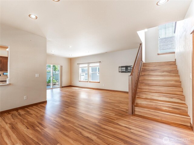 2452 NW Columbia Ave Unit 25, East Wenatchee, WA 98802 - unfurnished living room with stairway, light wood-style floors, recessed lighting, and baseboards