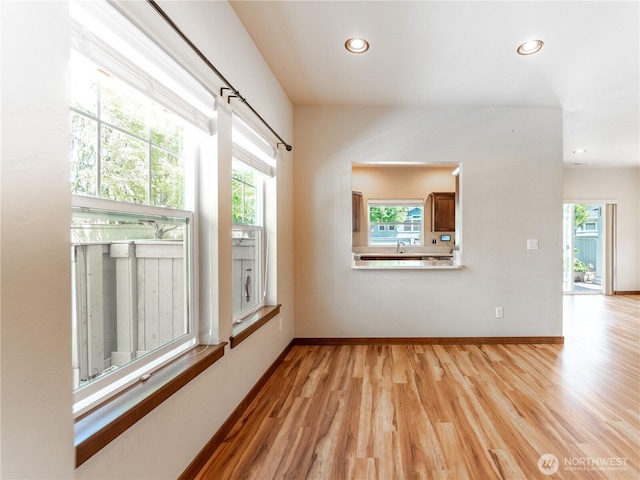 2452 NW Columbia Ave Unit 25, East Wenatchee, WA 98802 - empty room featuring plenty of natural light, light wood-style floors, recessed lighting, and baseboards