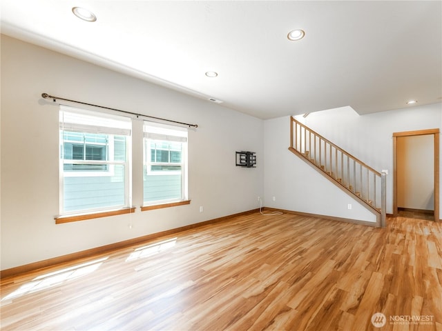 2452 NW Columbia Ave Unit 25, East Wenatchee, WA 98802 - unfurnished living room featuring light wood-type flooring, stairway, baseboards, and recessed lighting