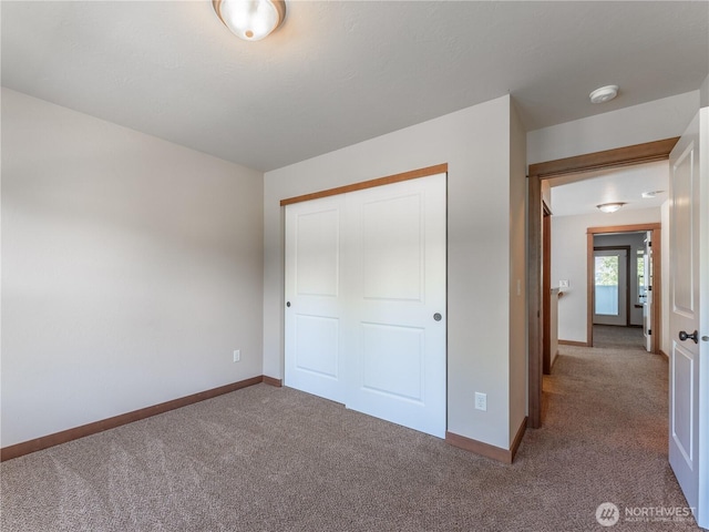 2452 NW Columbia Ave Unit 25, East Wenatchee, WA 98802 - unfurnished bedroom featuring carpet floors, baseboards, and a closet