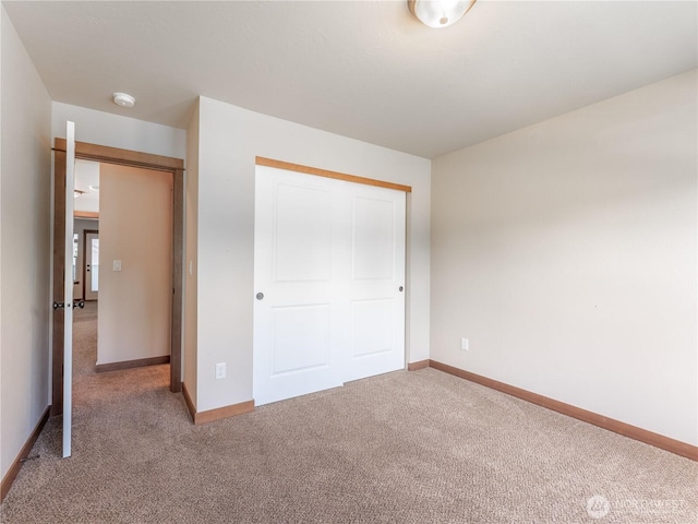2452 NW Columbia Ave Unit 25, East Wenatchee, WA 98802 - unfurnished bedroom with carpet flooring, baseboards, and a closet