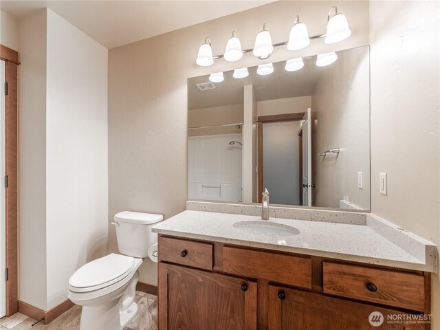 2452 NW Columbia Ave Unit 25, East Wenatchee, WA 98802 - full bath featuring vanity, toilet, baseboards, and a shower