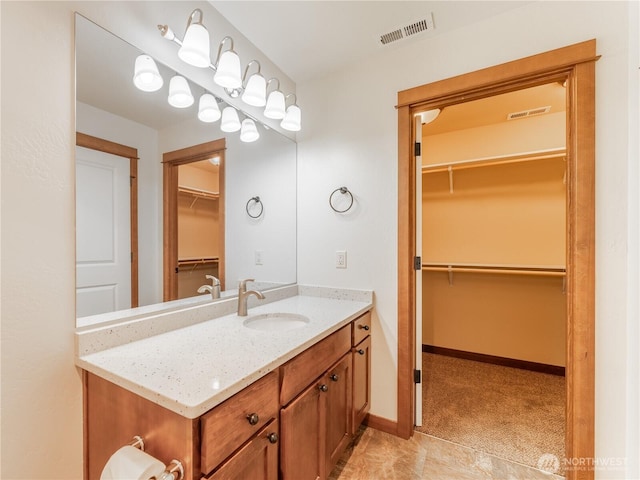 2452 NW Columbia Ave Unit 25, East Wenatchee, WA 98802 - bathroom featuring vanity, a spacious closet, and baseboards