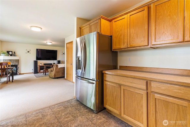 4155 Aurora Loop, Bellingham, WA 98226 - kitchen with stainless steel fridge with ice dispenser, open floor plan, a multi sided fireplace, carpet flooring, and light countertops