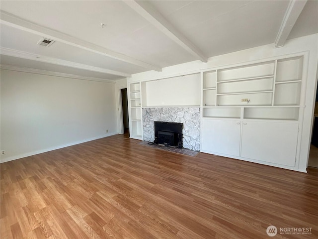 425 Henry St, Shelton, WA 98584 - unfurnished living room featuring beam ceiling, wood finished floors, baseboards, and built in features