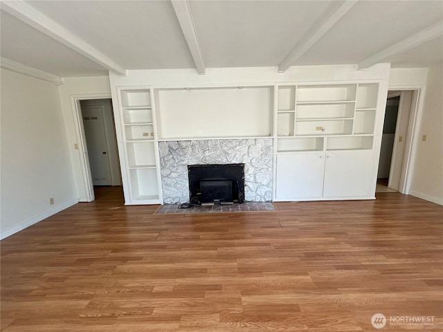 425 Henry St, Shelton, WA 98584 - unfurnished living room with beamed ceiling, built in features, light wood-type flooring, and baseboards