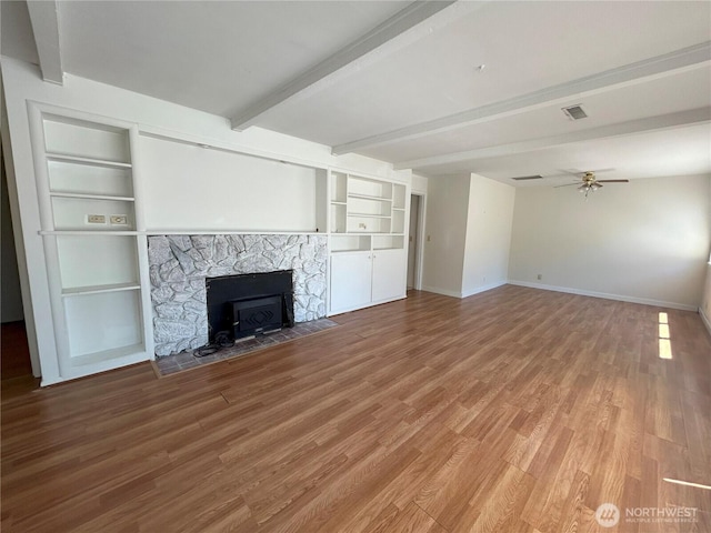 425 Henry St, Shelton, WA 98584 - unfurnished living room with a ceiling fan, wood finished floors, beamed ceiling, baseboards, and built in shelves