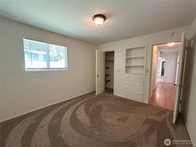 425 Henry St, Shelton, WA 98584 - unfurnished bedroom with carpet floors, a textured wall, a closet, and baseboards