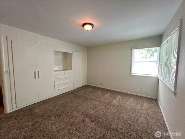 425 Henry St, Shelton, WA 98584 - unfurnished bedroom with dark carpet, baseboards, and a closet