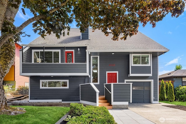 4142 52nd Ave SW, Seattle, WA 98116 - view of front of house featuring driveway, an attached garage, and roof with shingles
