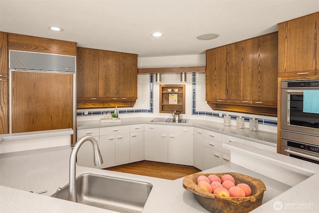 4142 52nd Ave SW, Seattle, WA 98116 - kitchen featuring paneled built in fridge, light countertops, white cabinetry, black electric cooktop, and recessed lighting
