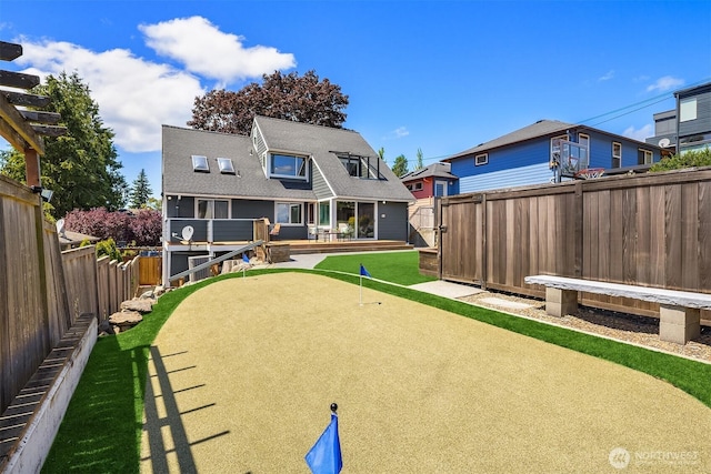 4142 52nd Ave SW, Seattle, WA 98116 - rear view of property with a putting green and a fenced backyard