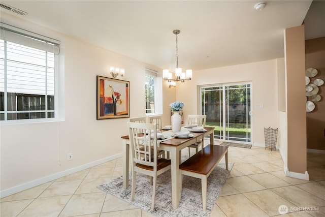 19678 Marine View Dr SW, Normandy Park, WA 98166 - dining space featuring light tile patterned floors, a chandelier, and baseboards