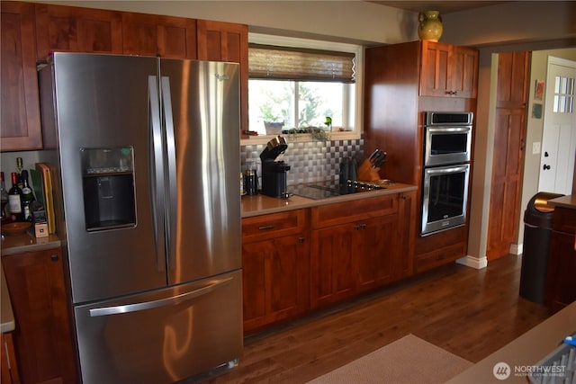 8708 Rd K Rd NE, Moses Lake, WA 98837 - kitchen with stainless steel appliances, dark wood-type flooring, light countertops, decorative backsplash, and brown cabinets