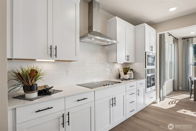 13920 181st St E Unit 64, Puyallup, WA 98374 - kitchen featuring wall chimney exhaust hood, stainless steel oven, black electric cooktop, white cabinetry, and decorative backsplash