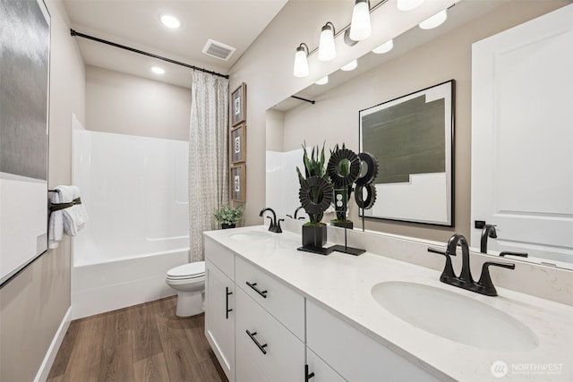 13920 181st St E Unit 64, Puyallup, WA 98374 - full bath with double vanity, wood finished floors, toilet, shower / bath combo with shower curtain, and recessed lighting