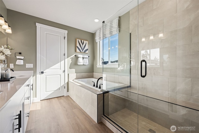13920 181st St E Unit 64, Puyallup, WA 98374 - full bath with a bath, double vanity, a stall shower, wood finished floors, and recessed lighting