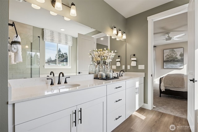 13920 181st St E Unit 64, Puyallup, WA 98374 - ensuite bathroom featuring wood finished floors, double vanity, ceiling fan, a tile shower, and baseboards