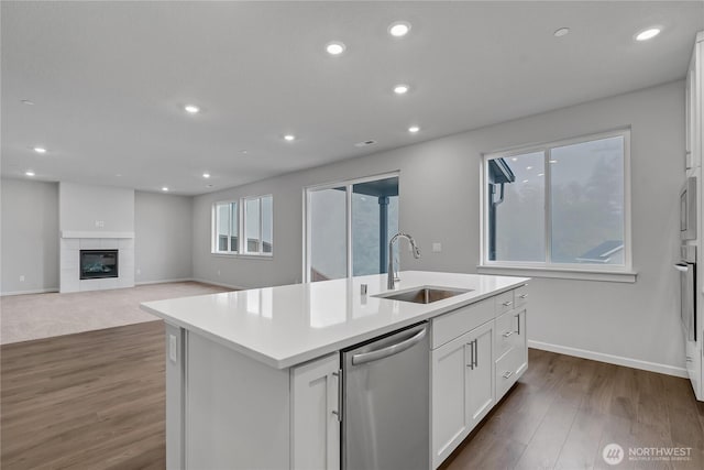 2609 S 7th Way, Ridgefield, WA 98642 - kitchen featuring stainless steel dishwasher, a sink, white cabinetry, an island with sink, and light countertops