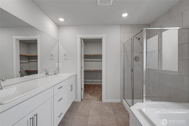 2609 S 7th Way, Ridgefield, WA 98642 - bathroom with a walk in closet, a stall shower, double vanity, a bath, and recessed lighting