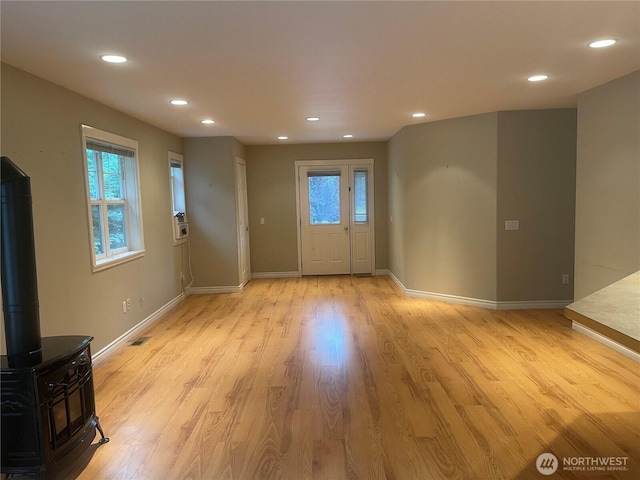 528 Chinook Way, Friday Harbor, WA 98250 - foyer entrance featuring recessed lighting, light wood-style floors, cooling unit, and a wood stove